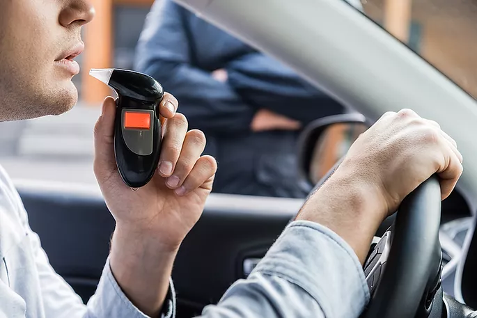 Driver about to use a breathalyzer after being pulled over