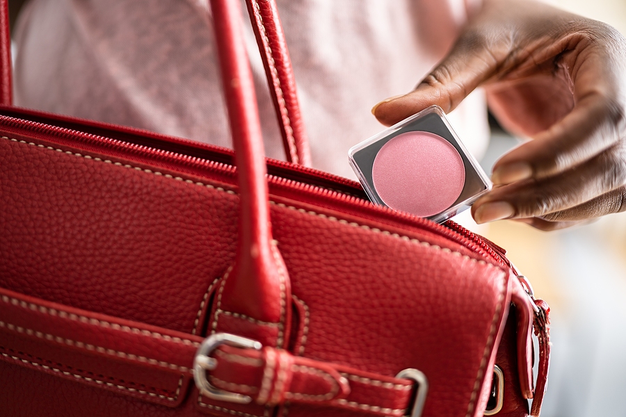 Woman Stealing Compact Makeup Powder In Retail Store.